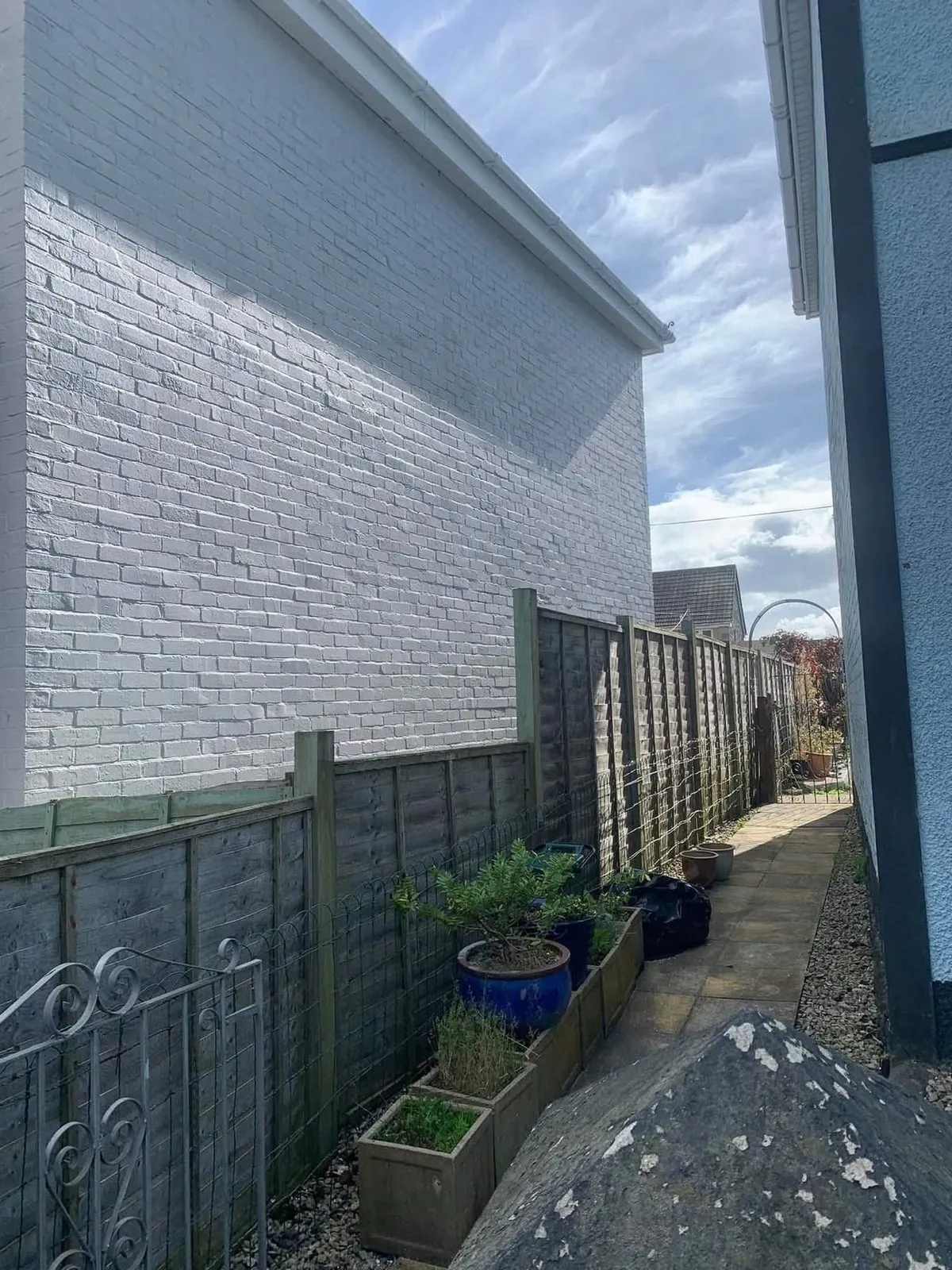 Freshly painted brick wall after preparation and masonry paint in Penryn